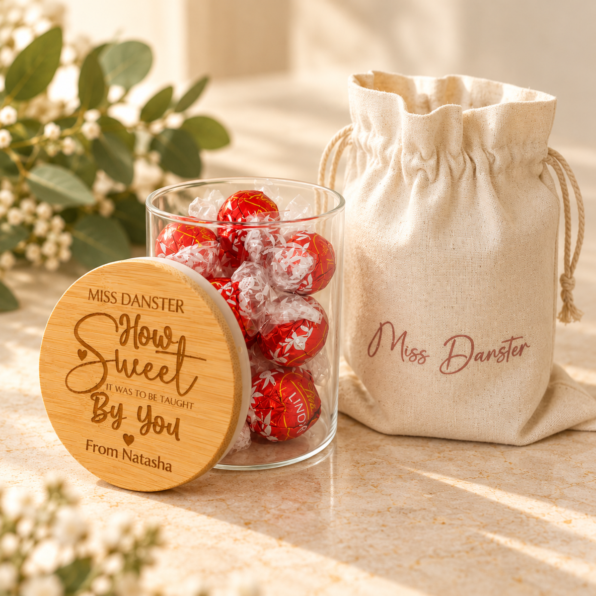 Personalised teacher gift jar with engraved bamboo lid, shown open alongside its matching personalised cotton drawstring gift bag.