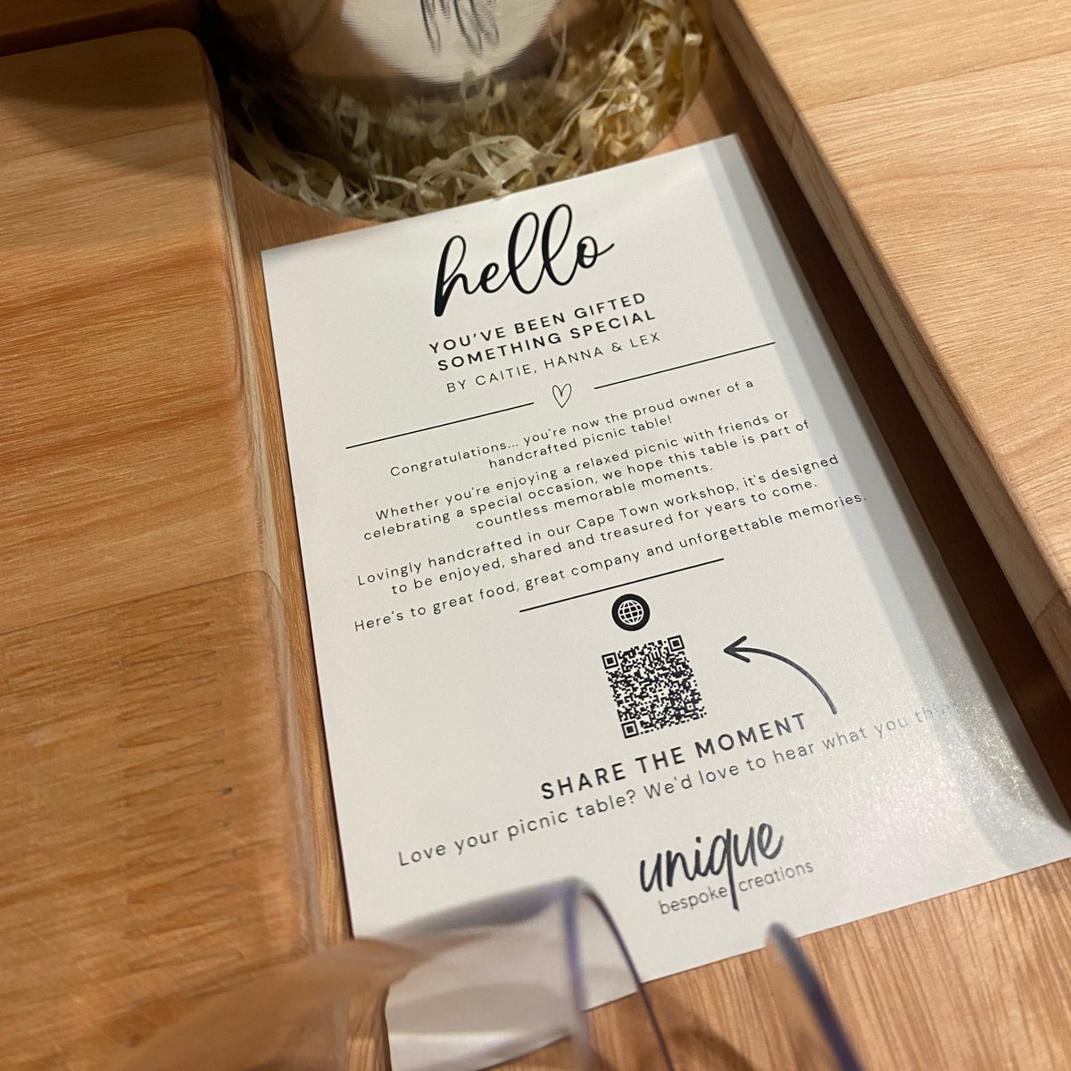 Close-up showing handcrafted wooden picnic table with authenticity certificate.