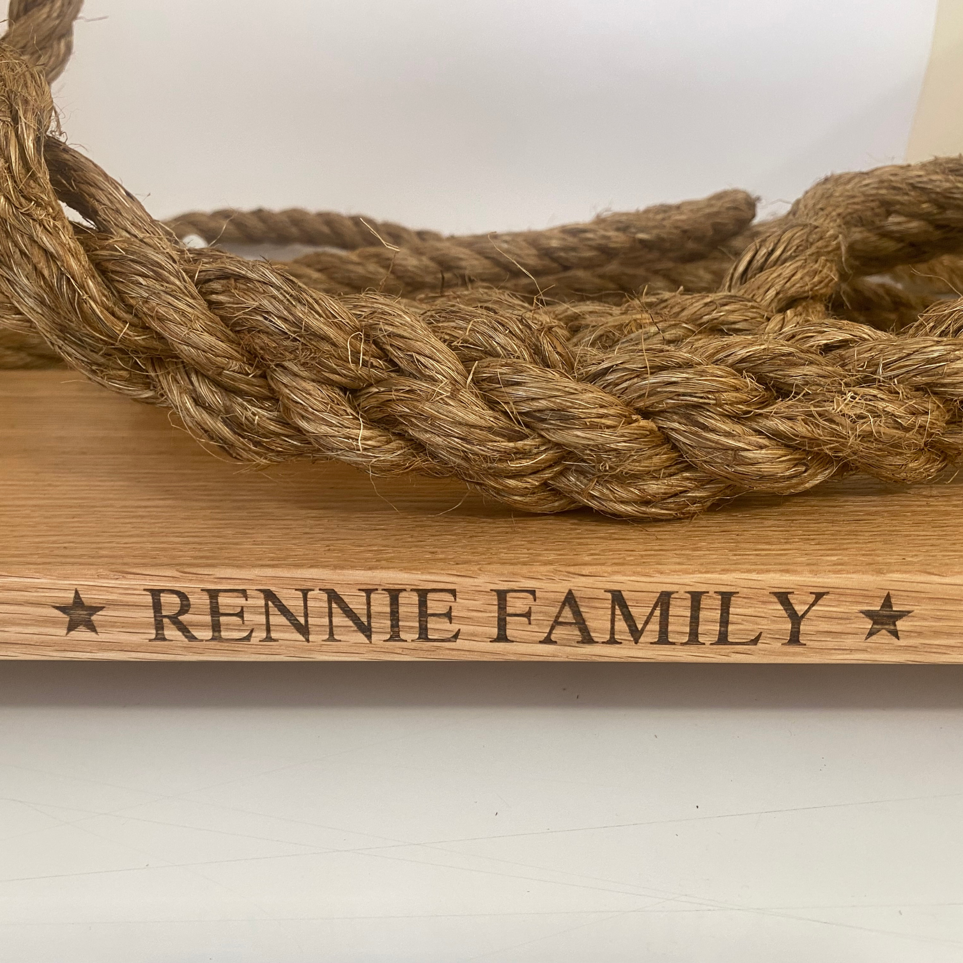 Personalised solid oak tree swing with natural manila rope and engraved family name