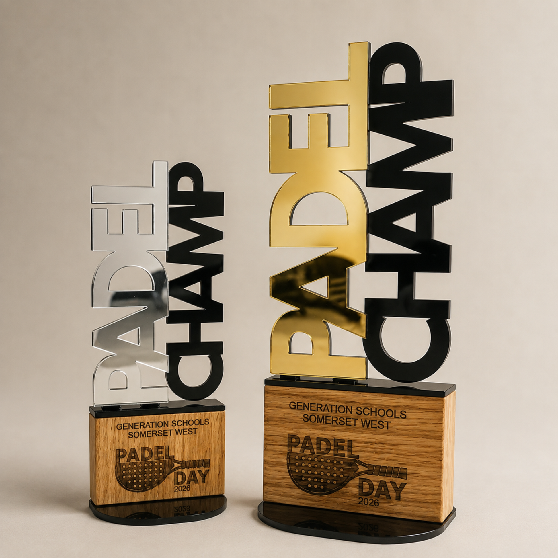 Personalised Padel CHAMP trophies in mirror gold and silver with engraved wooden bases
