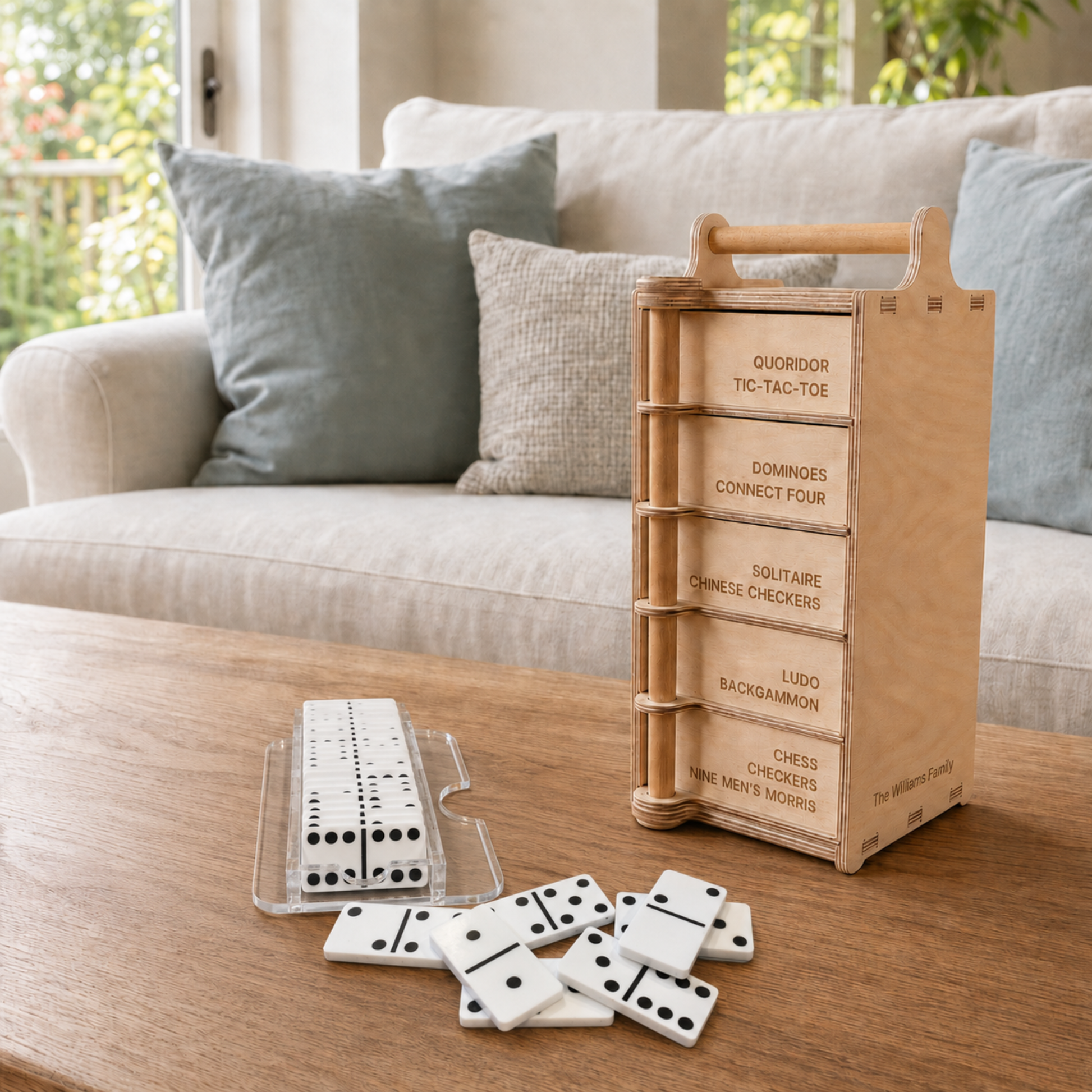 White acrylic dominoes with a clear storage case beside the Games Tower